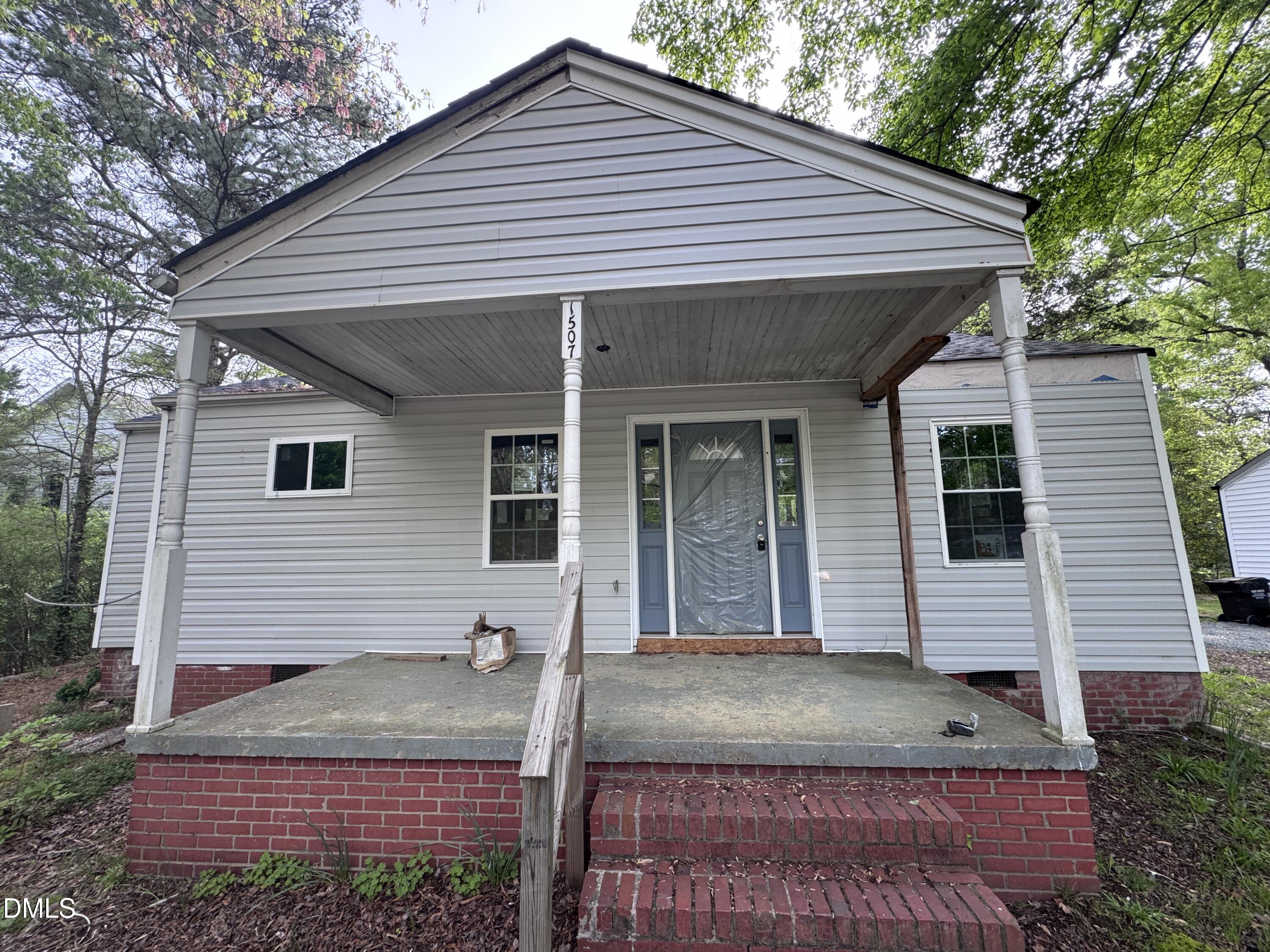 1507 Echo Road Durham, NC 27707 - Photo 3 of 13 a view of house with a yard and large tree