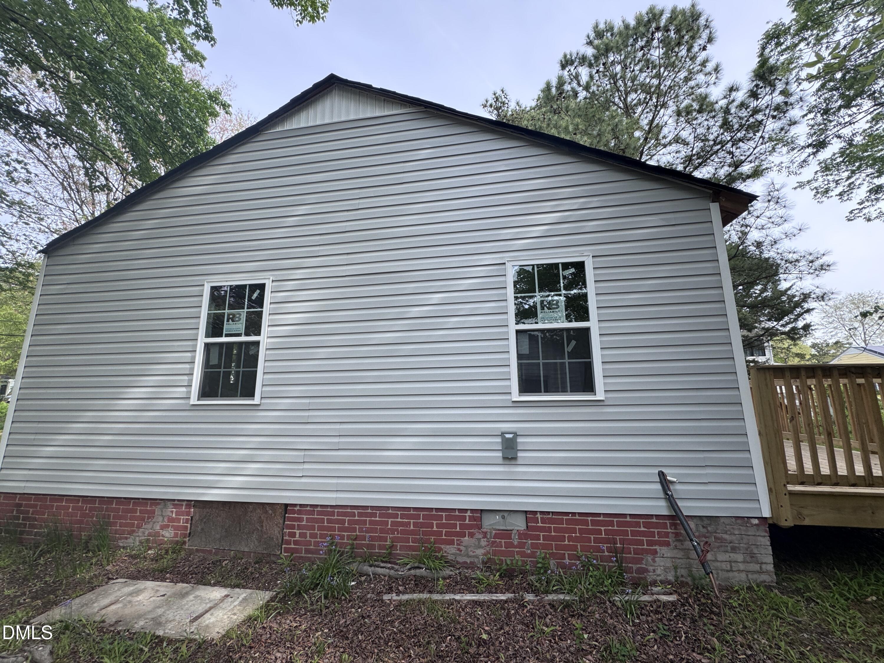 1507 Echo Road Durham, NC 27707 - Photo 4 of 13 a view of a house with a yard and garage