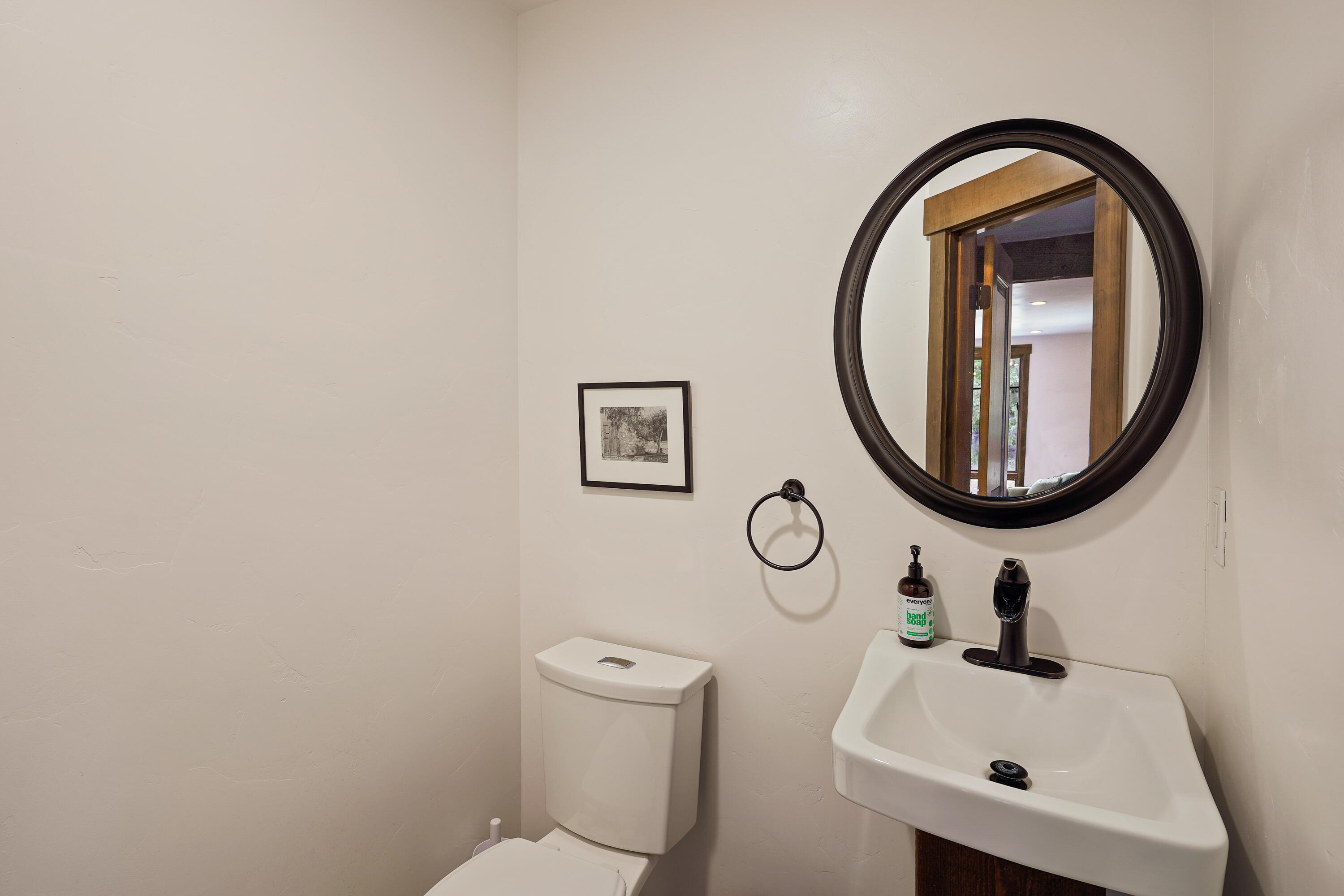 64732 Hunnell Road Bend, OR 97703 - Photo 18 of 51 a bathroom with a toilet sink and mirror