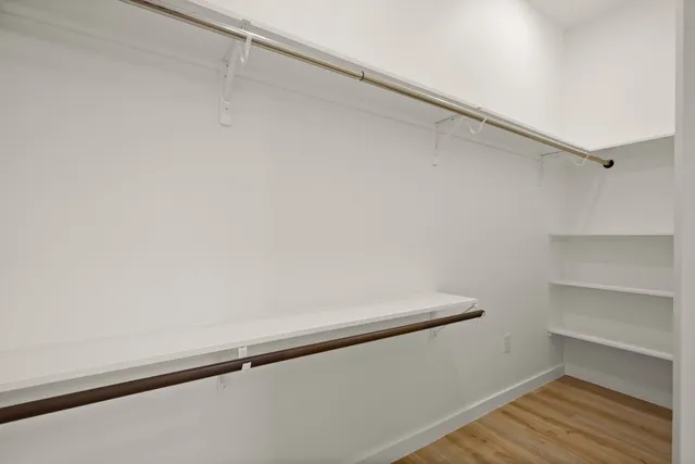 an empty room with windows and closet