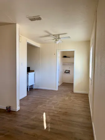 a view of a big room with closet and wooden floor