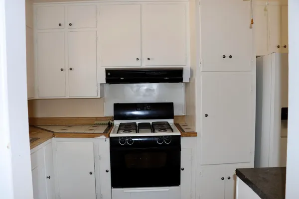 a kitchen with cabinets and appliances