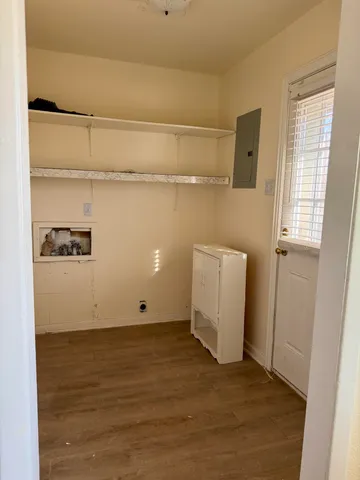 a view of storage and utility room with wooden floor