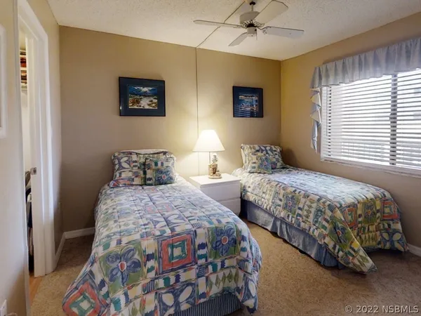 a bedroom with a bed and a lamp