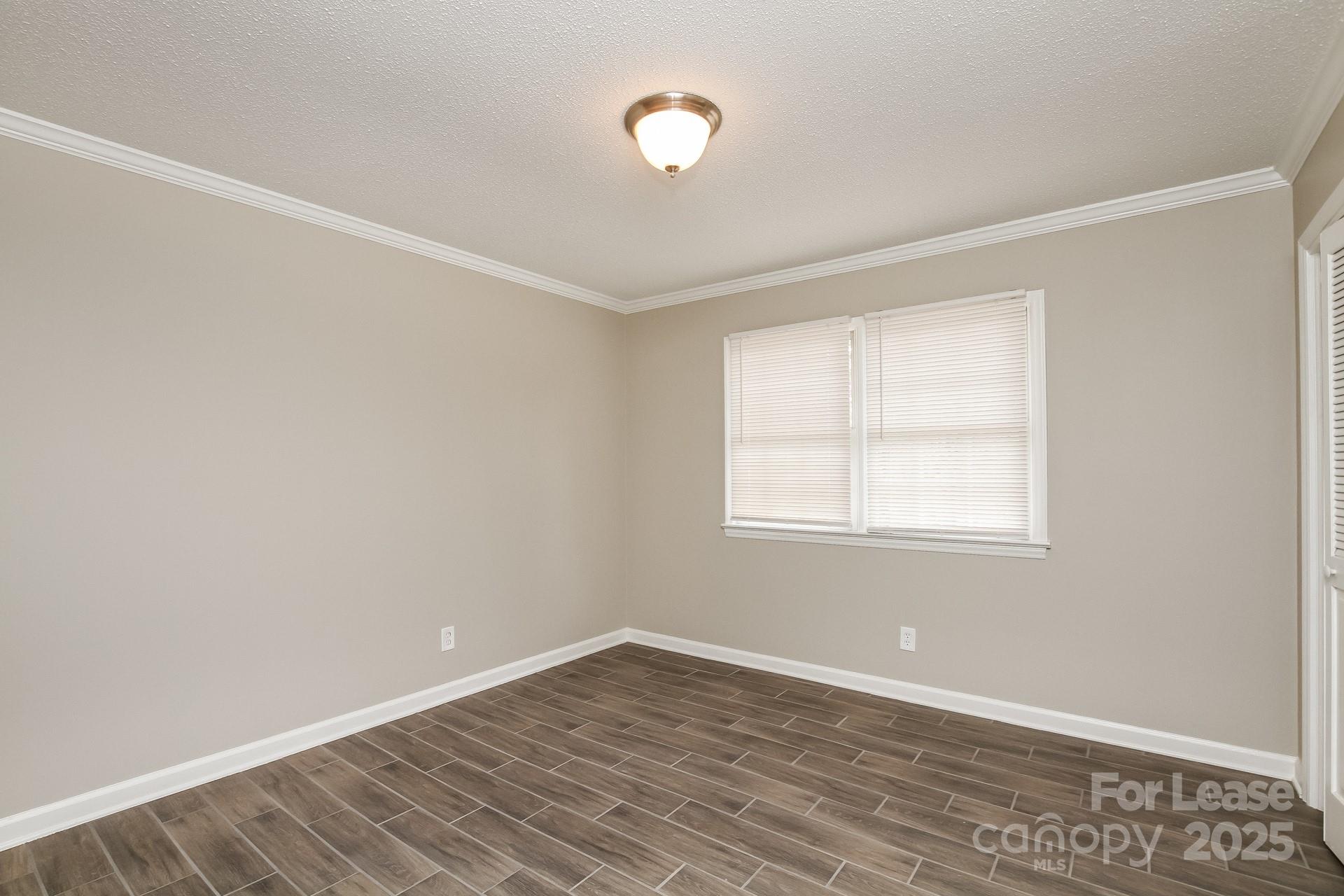 144 Buffaloway Road Statesville, NC 28677 - Photo 13 of 16 an empty room with wooden floor and windows