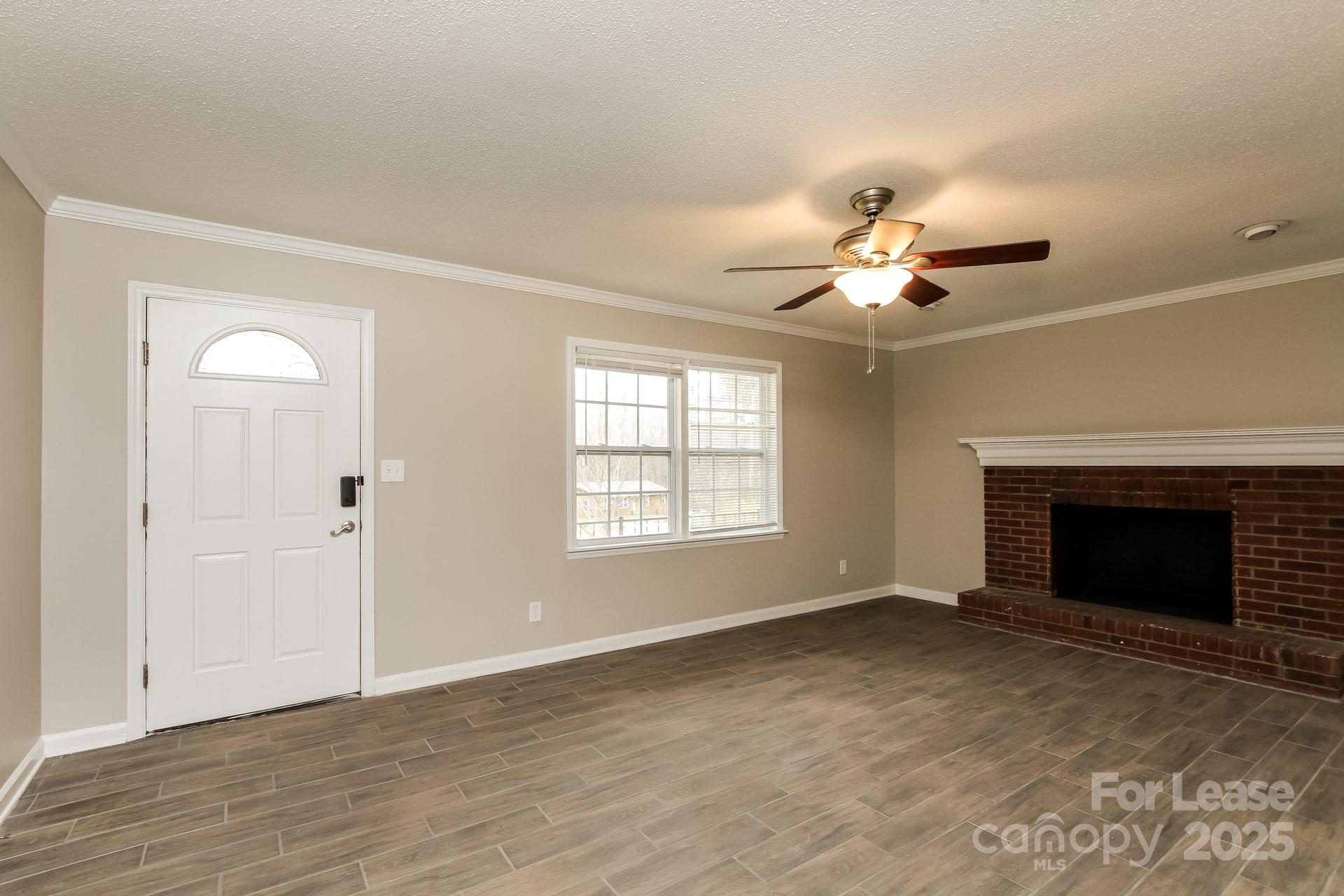 144 Buffaloway Road Statesville, NC 28677 - Photo 2 of 16 a view of an empty room with a fireplace and a window