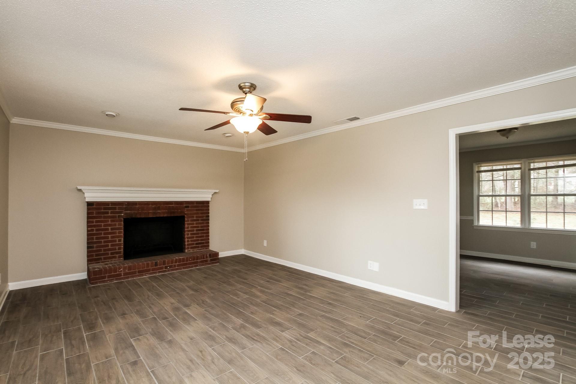 144 Buffaloway Road Statesville, NC 28677 - Photo 3 of 16 a view of an empty room with a fireplace and a window
