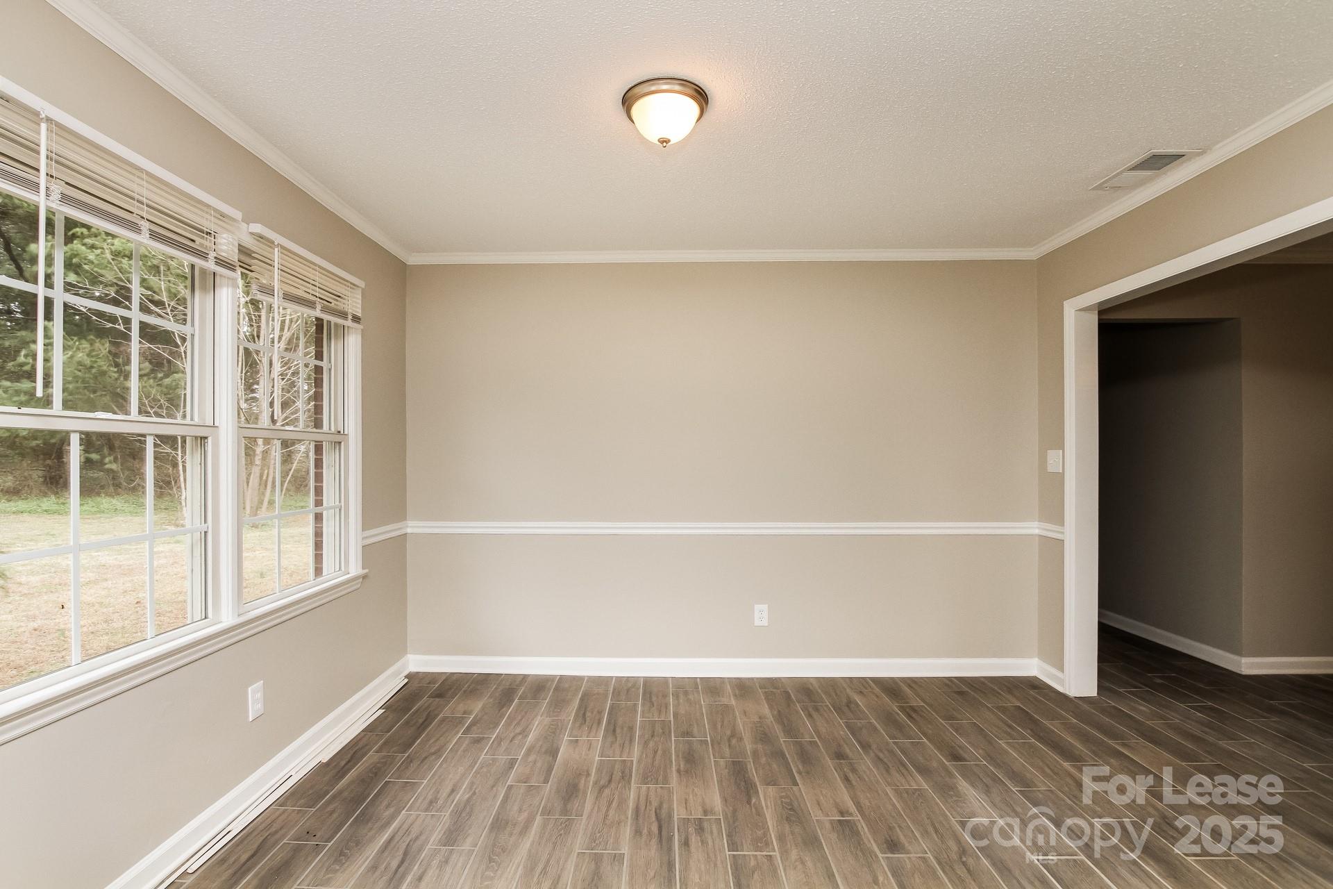 144 Buffaloway Road Statesville, NC 28677 - Photo 5 of 16 a view of an empty room with wooden floor and a window