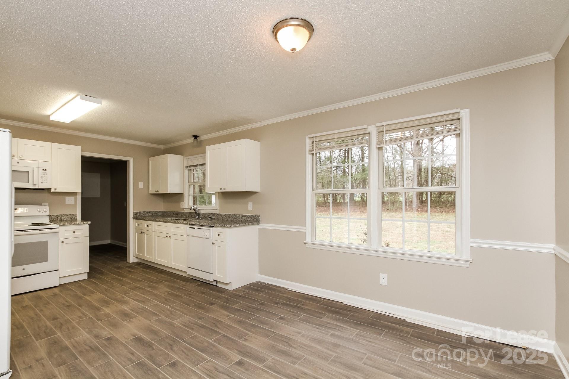 144 Buffaloway Road Statesville, NC 28677 - Photo 6 of 16 a kitchen with a refrigerator and wooden floor