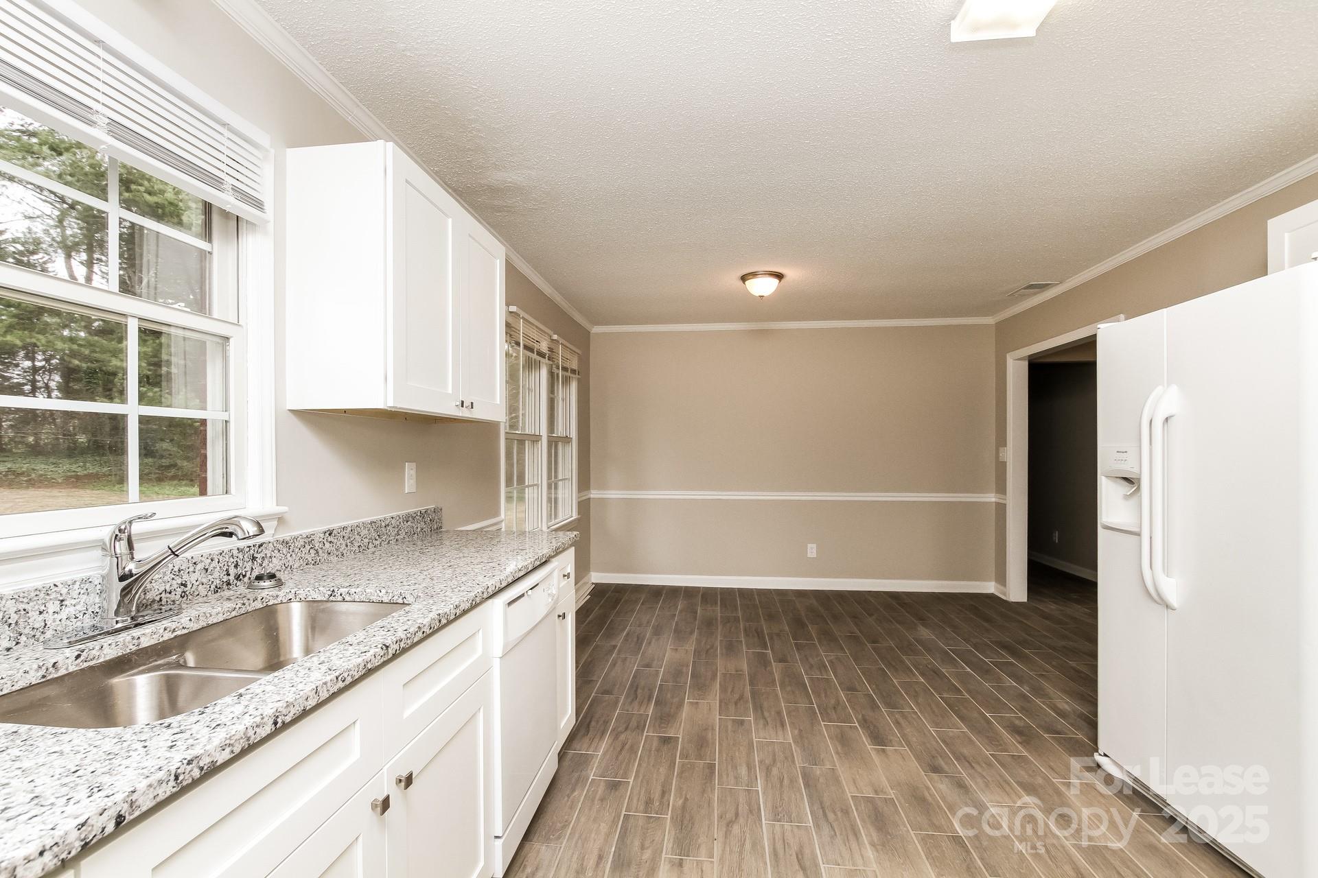 144 Buffaloway Road Statesville, NC 28677 - Photo 7 of 16 a kitchen with granite countertop a sink and a stove top oven