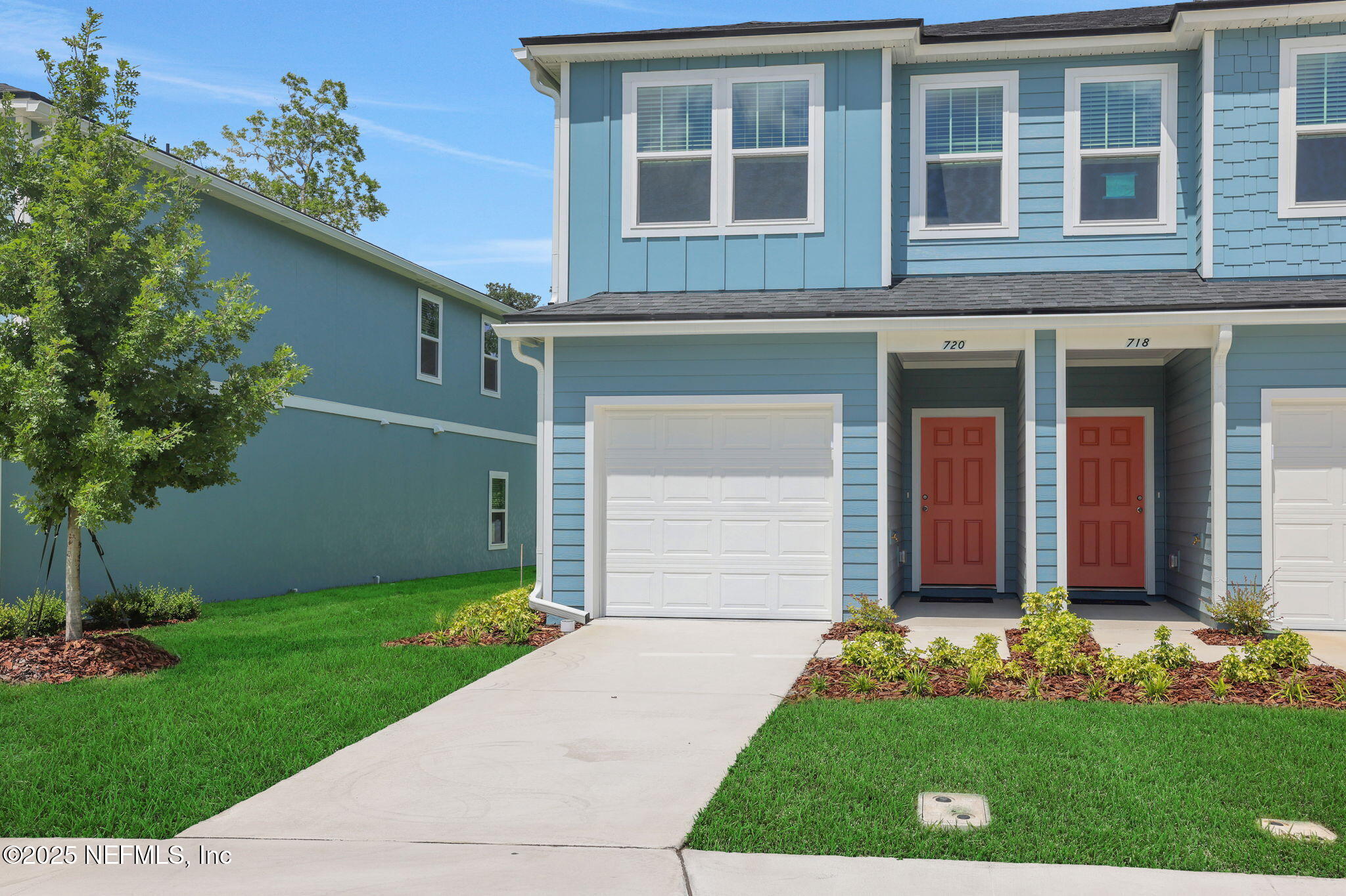 720 Sailor Grove Lane Jacksonville, FL 32221 - Photo 1 of 32 a front view of a house with a yard and garage