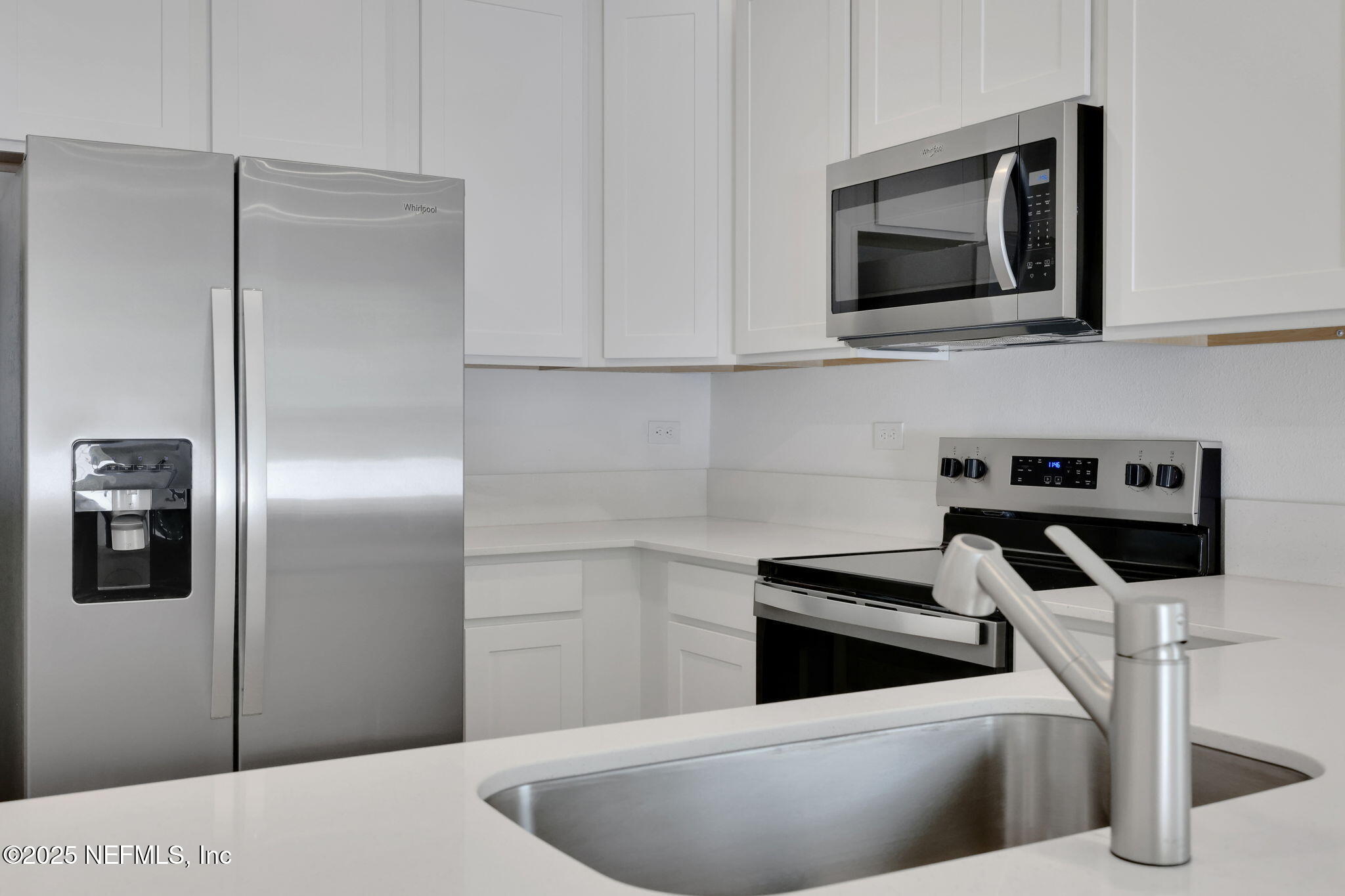 720 Sailor Grove Lane Jacksonville, FL 32221 - Photo 8 of 32 a kitchen with stainless steel appliances kitchen island a refrigerator sink and microwave