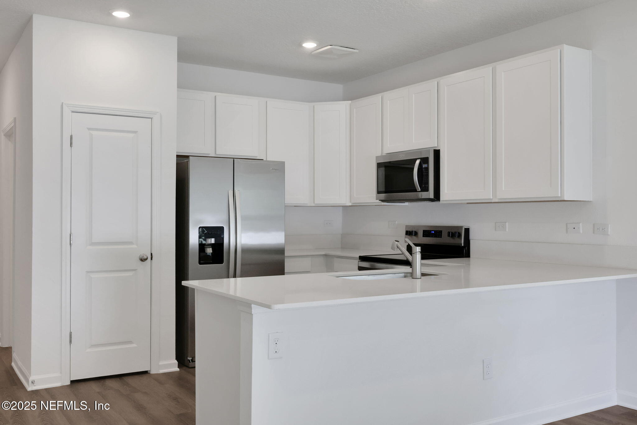 720 Sailor Grove Lane Jacksonville, FL 32221 - Photo 9 of 32 a kitchen with stainless steel appliances a refrigerator a stove a microwave and cabinets