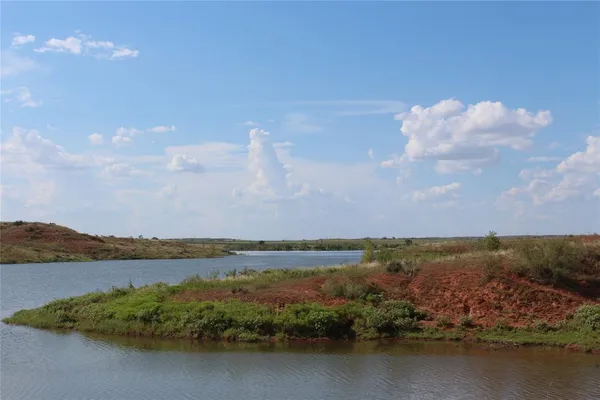 a view of a lake with houses in the back