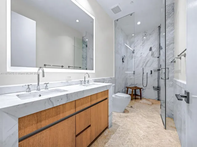 a bathroom with a double vanity sink mirror double and shower