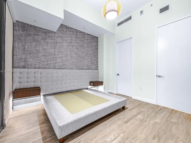 a bedroom with a bed and a ceiling fan