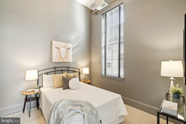 a bedroom with a bed and a window