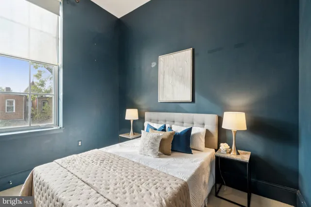 a bedroom with a bed and window