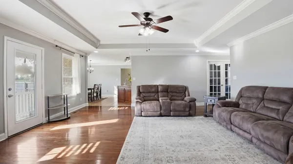 a living room with furniture and wooden floor