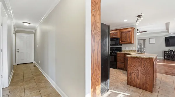 a view of kitchen with kitchen island wooden floor center island and stainless steel appliances