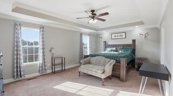 a living room with furniture and a ceiling fan
