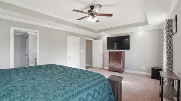 a bedroom with a bed and a chandelier