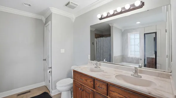 a bathroom with a sink double vanity and a mirror
