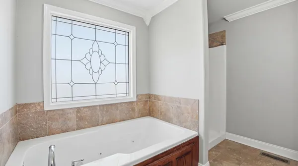 a bathroom with a bathtub and window