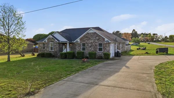 an aerial view of a house with a big yard
