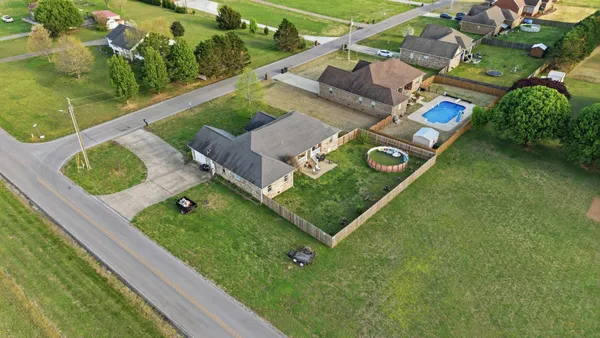 an aerial view of a golf course with parking space