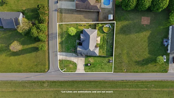 an aerial view of ocean and residential houses with outdoor space