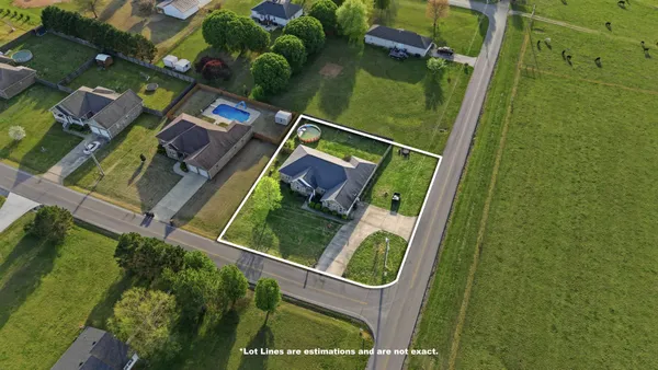 an aerial view of a house with a garden swimming pool and outdoor seating