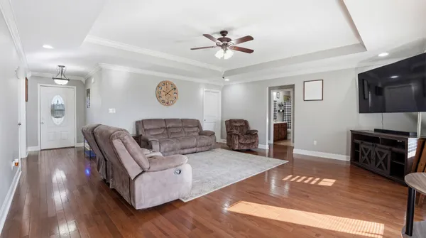 a living room with furniture and a wooden floor