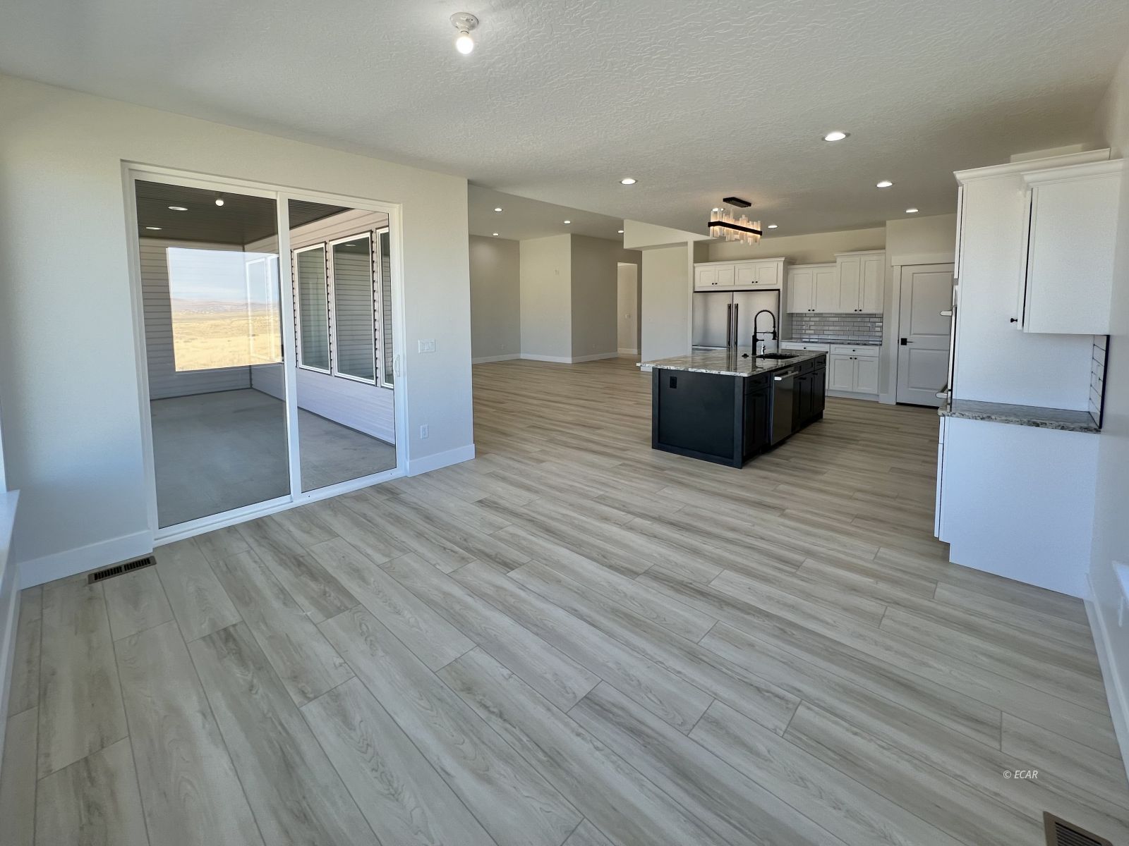 1597 Sun Vly Road, Unit C7 Spring Creek, NV 89815 - Photo 16 of 43 a room with stainless steel appliances kitchen island wooden floors granite counter tops and a view of living room