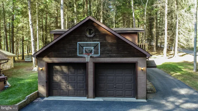 a backyard of a house with barbeque oven and a table and chairs
