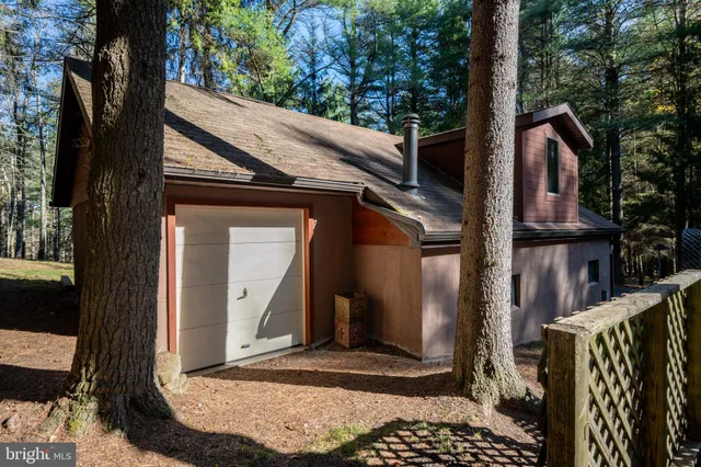 a kitchen with white cabinets and window