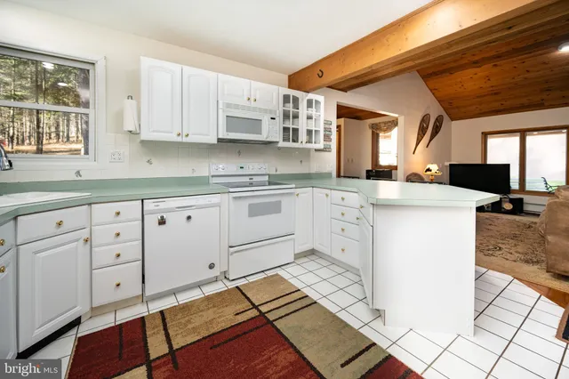 a view of a workspace with furniture and windows