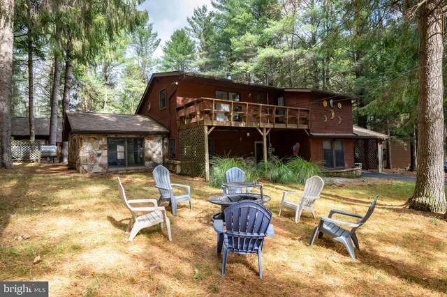 a view of a house with backyard porch and sitting area