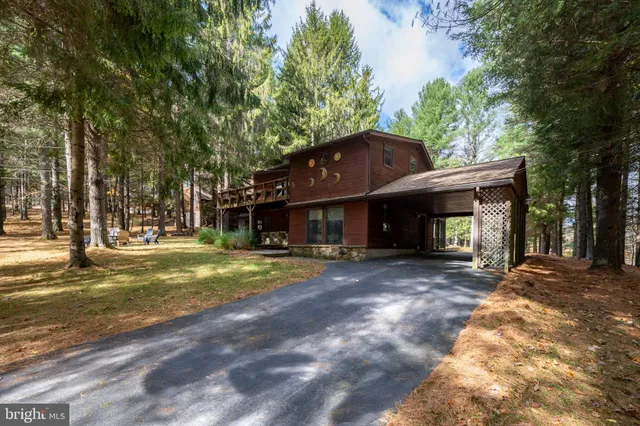 a view of a house with a yard and tree s