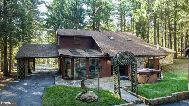 a view of a house with backyard and a tree
