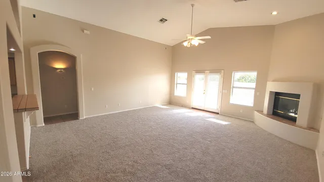 a view of empty room with a fireplace and large windows