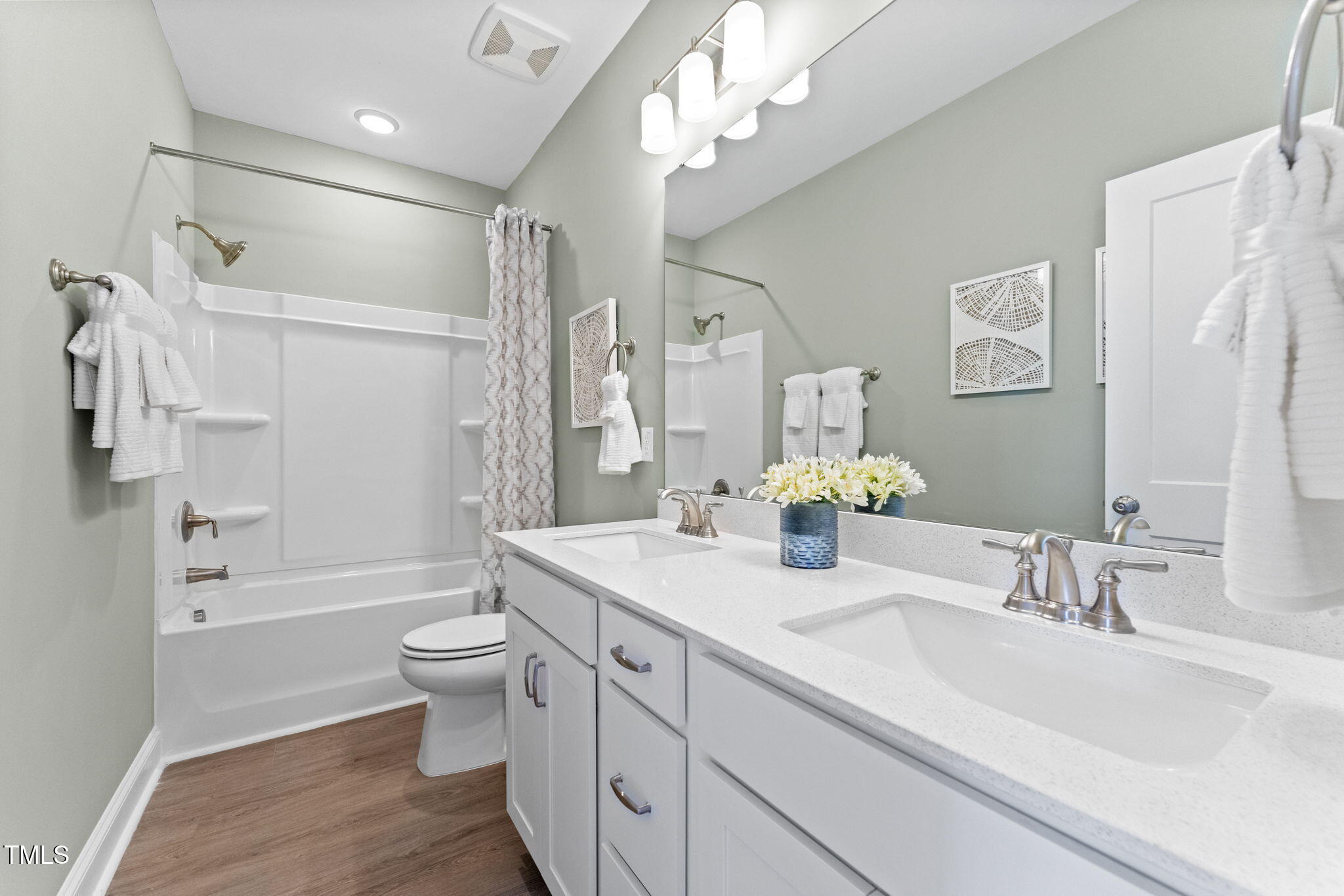 1242 Coach Sta Alley, Unit 201 Raleigh, NC 27601 - Photo 18 of 22 a bathroom with a double vanity sink toilet mirror and shower
