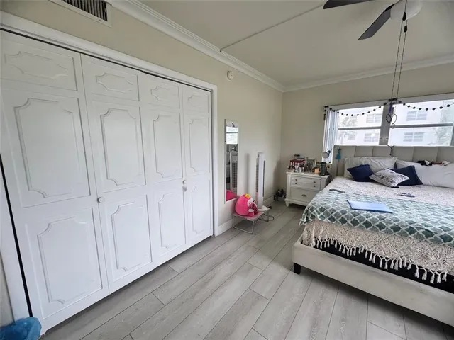 a spacious bedroom with a bed and window