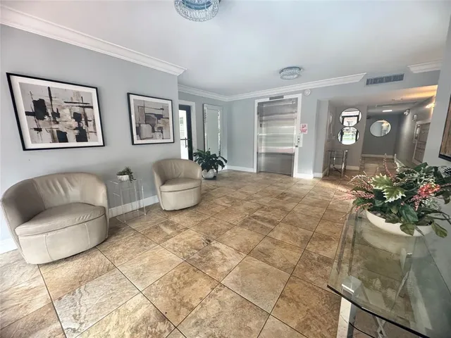 a living room with furniture and flowers