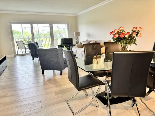a view of a dining room with furniture and a window