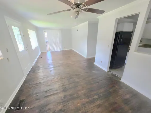a view of a hallway with a chandelier fan and wooden floor
