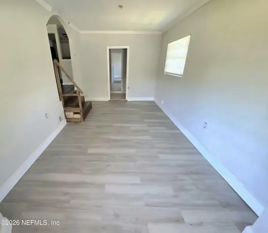 a view of a room with wooden floor and stairs