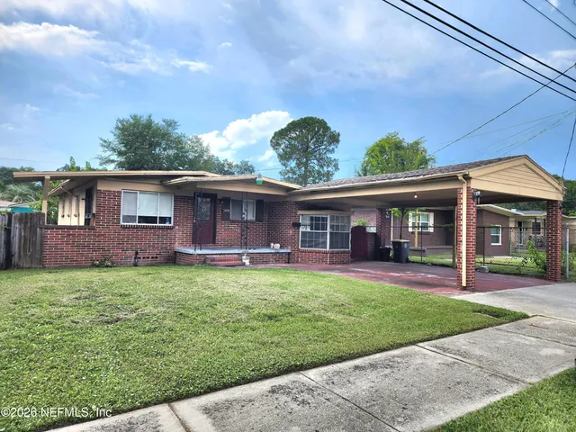 a front view of a house with a garden