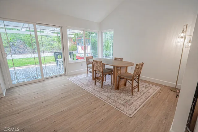 a view of a work space with wooden floor and a rug