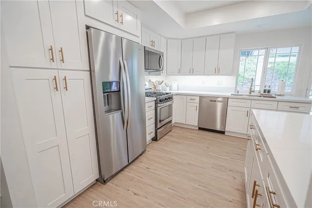 a kitchen with a refrigerator sink and stove